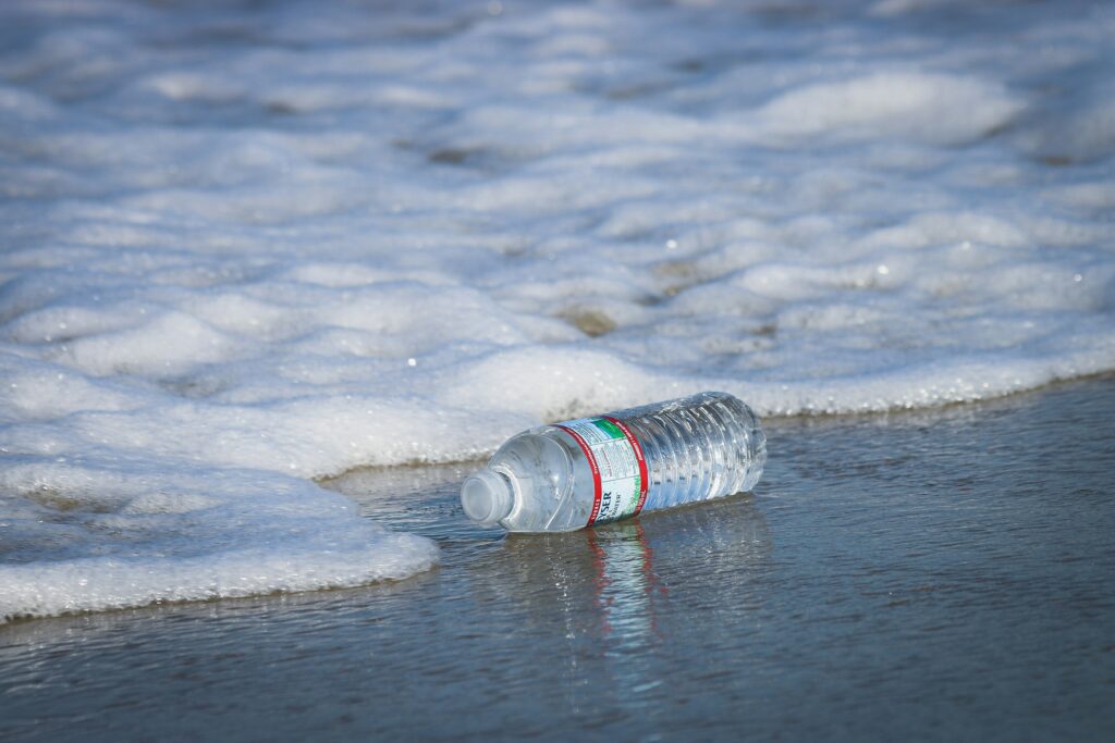 A plastic water bottle washed up on the shoreline.